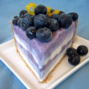 Close up of a slice of Blueberry Ice Cream Pie on a white plate.