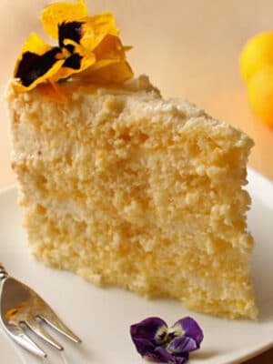 Slice of Lemon-Mascarpone Layer Cake on a white plate.