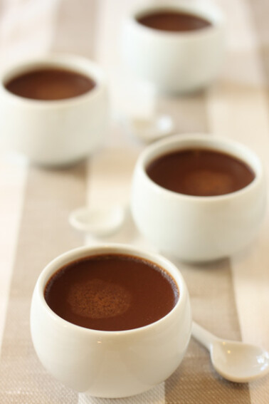 4 Chocolate Pots de Crème on a white surface.