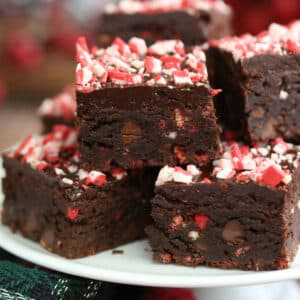 Cut Peppermint Crunch Brownies on a white plate.