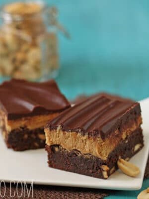 2 Layered Peanut Butter Brownies on a square white plate.