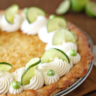 Outside edge of Lime-Coconut Pie, finished with whipped cream, lime slices, and green Sixlets.