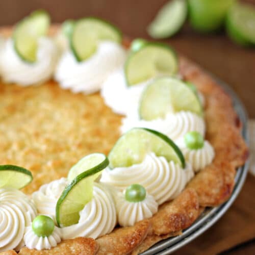 Outside edge of Lime-Coconut Pie, finished with whipped cream, lime slices, and green Sixlets.
