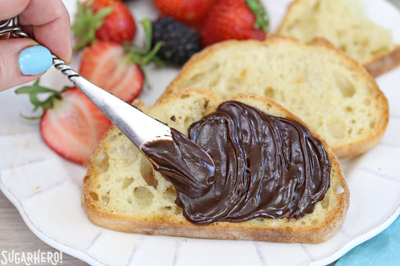 Lick-The-Knife-Clean Chocolate Spread - Chocolate spread being smeared onto toast. | From SugarHero.com