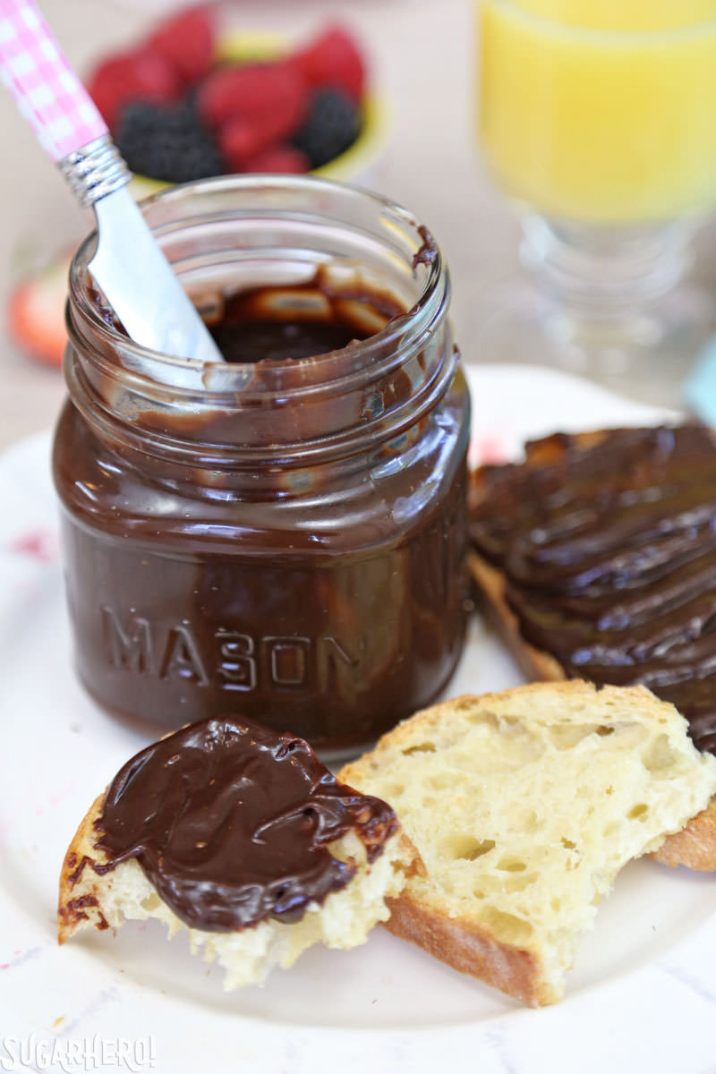 Lick-The-Knife-Clean Chocolate Spread - A photo of the chocolate spread in a jar with some on a piece of toast. | From SugarHero.com