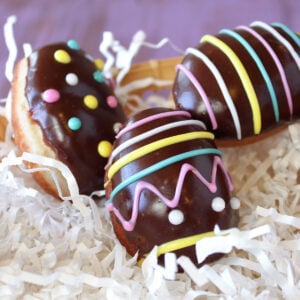 Easter Egg Doughnuts on white paper shreds.