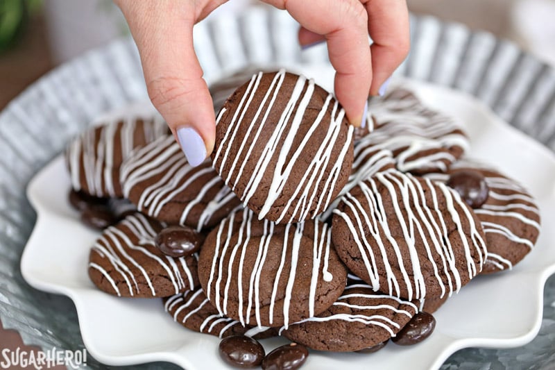 Junior Mint Cookies are soft and chewy chocolate-mint cookies, with a Junior Mint baked right into the center! | From SugarHero.com Junior Mint Cookies - chocolate-mint cookies with a white chocolate drizzle | From SugarHero.com