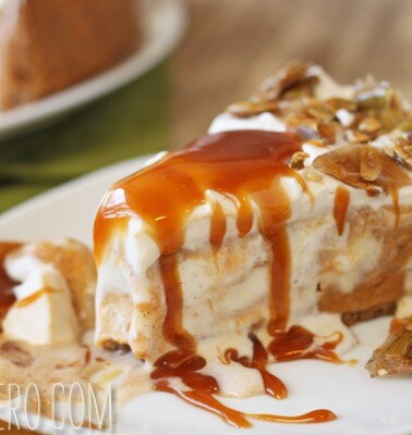 A slice of Pumpkin Ice Cream Pie on a white plate that is drizzled with caramel sauce and pumpkin brittle.