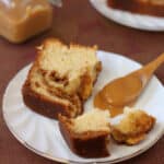 A broken slice of Dulce de Leche Swirl Pound Cake next to a spoonful of dulce de leche.