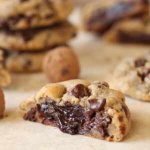 A Truffle-Stuffed Chocolate Chip Cookie cut in half to show gooey center.