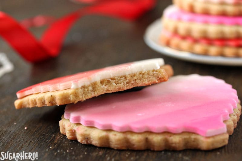 Brown Butter Heart Cookies - close-up on sugar cookie with a bite taken out of it | From SugarHero.com