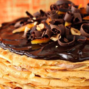 Close up of the top of Nutella Crepe Cake on a black cake plate.