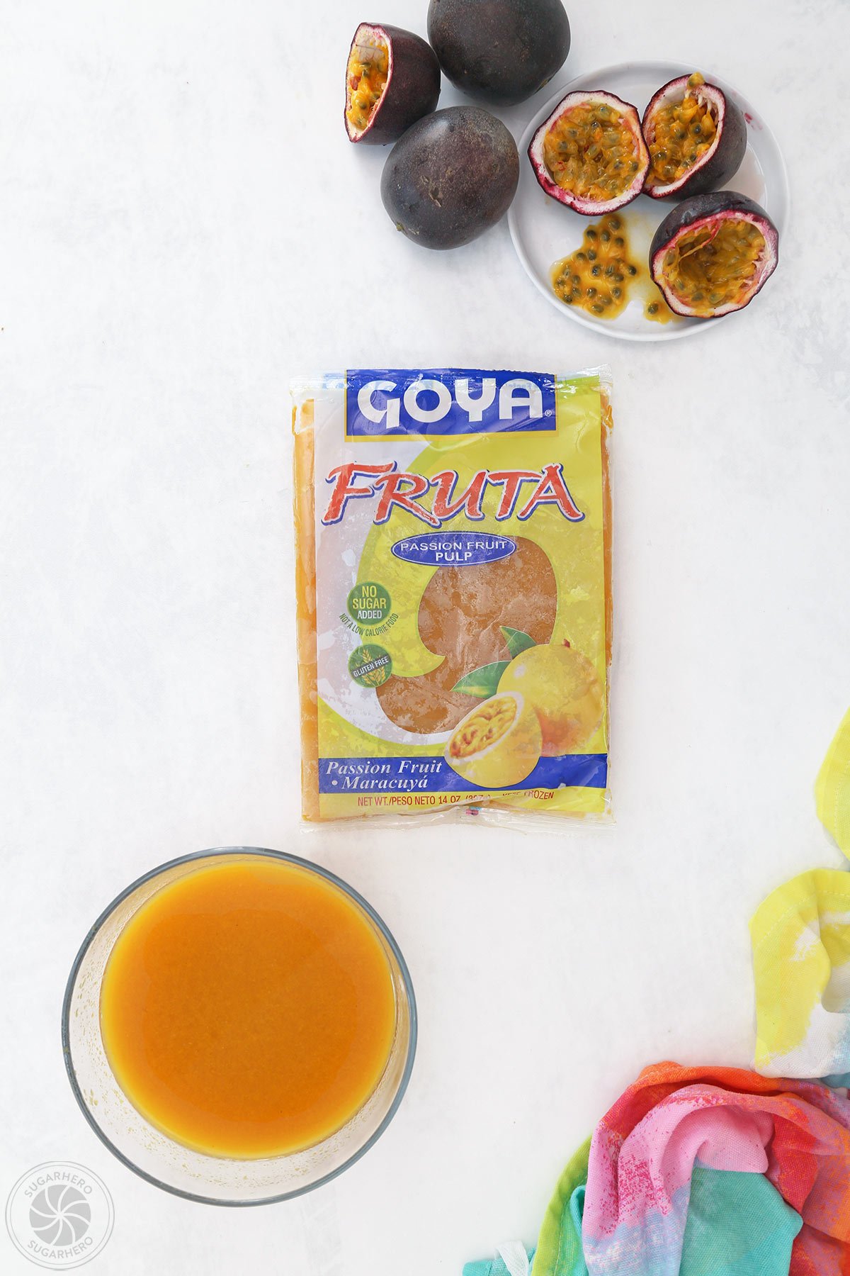 Frozen passion fruit pulp package next to a bowl of thawed pulp with passion fruit in the background.