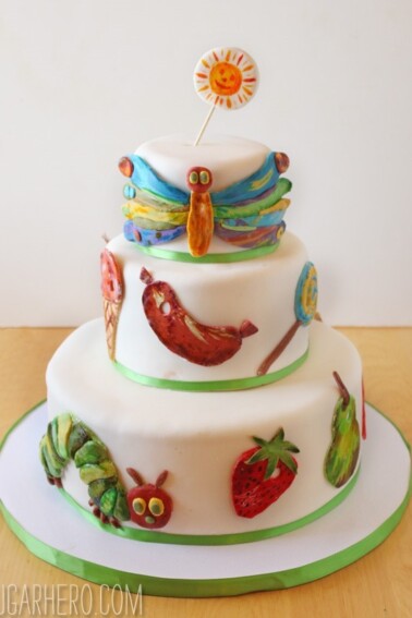 Close up of the Very Hungry Caterpillar Cake on a table with fondant designs.