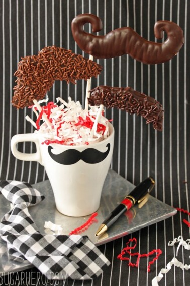 3 Chocolate Mustache Pops in a mustache mug.