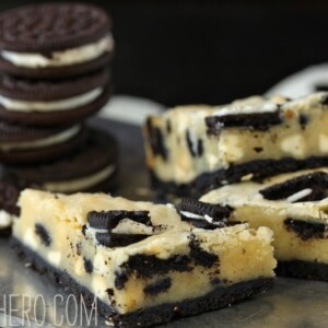 Close up of a few Cookies and Cream Oreo Cookie Bars with Oreos in the background.