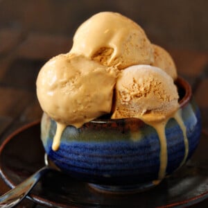 Several scoops of Salted Caramel Ice Cream in a blue ceramic bowl.