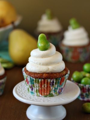 Close up of a Pear Cupcake with Honey Buttercream on a small white platter.