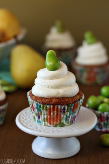 Close up of a Pear Cupcake with Honey Buttercream on a small white platter.