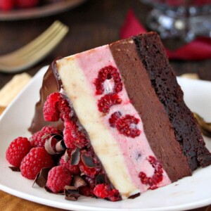 One slice of Chocolate Raspberry Mousse Cake on a white plate.