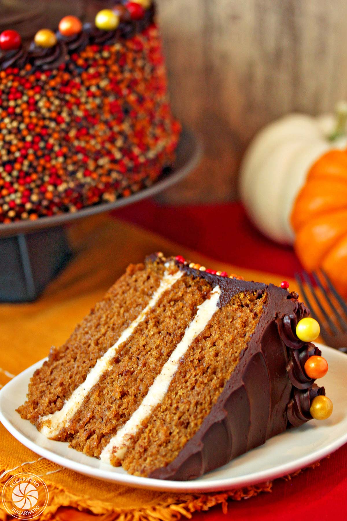 A slice of Pumpkin Layer Cake on a small white plate.