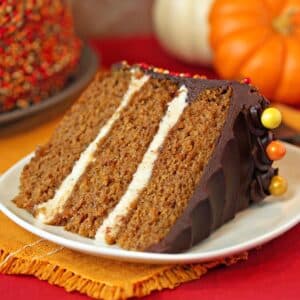 Close up of a Pumpkin Layer Cake on a brown cake platter.