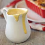 A small white pitcher of eggnog creme anglaise.