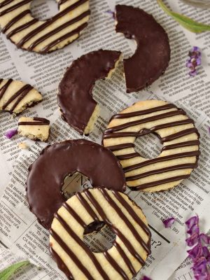 Fudge-Striped Shortbread Cookies on a piece of newspaper.