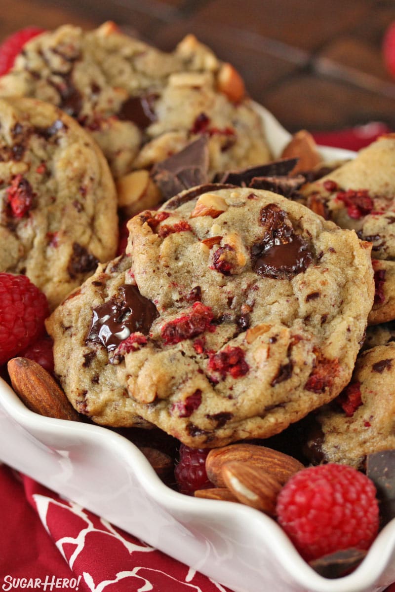 Raspberry Almond Chocolate Chunk Cookies - close-up shot of the cookies with chocolate chunks and raspberries. | From SugarHero.com