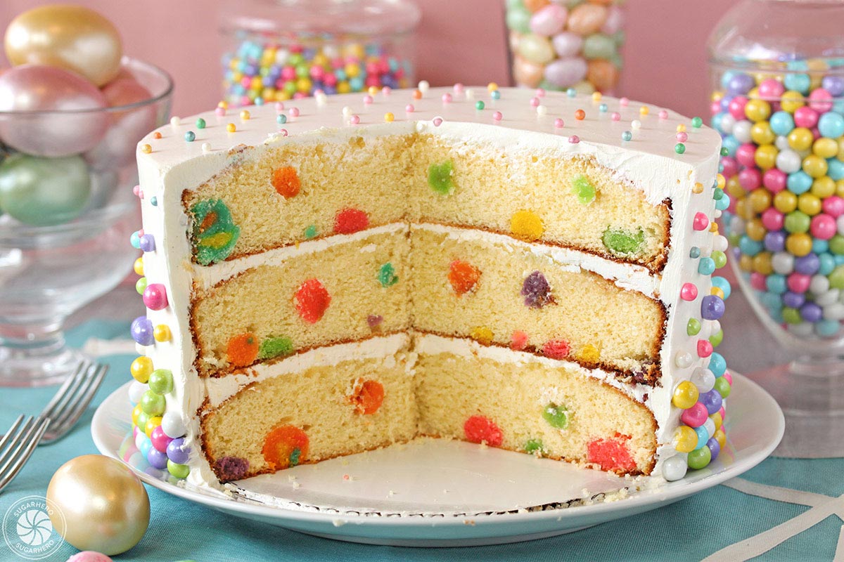 This Easter Polka Dot Cake is a gorgeous spring cake with polka dots on both the outside AND inside of the cake! Learn how to create this cute, easy cake with surprise polka dots inside. | From SugarHero.com Easter Polka Dot Cake - Polka dot cake with slices taken out, showing the polka dots inside. | From SugarHero.com