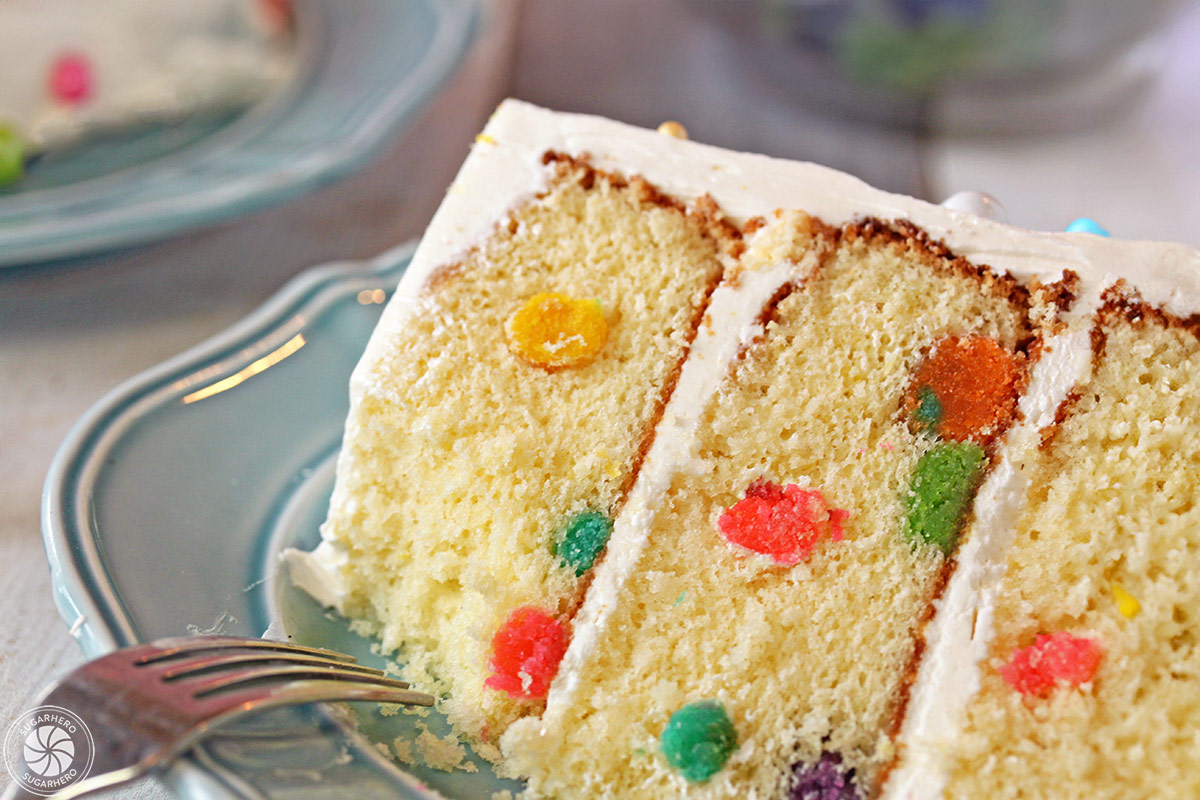 Easter Polka Dot Cake - A slice of cake with a bite taken out. | From SugarHero.com