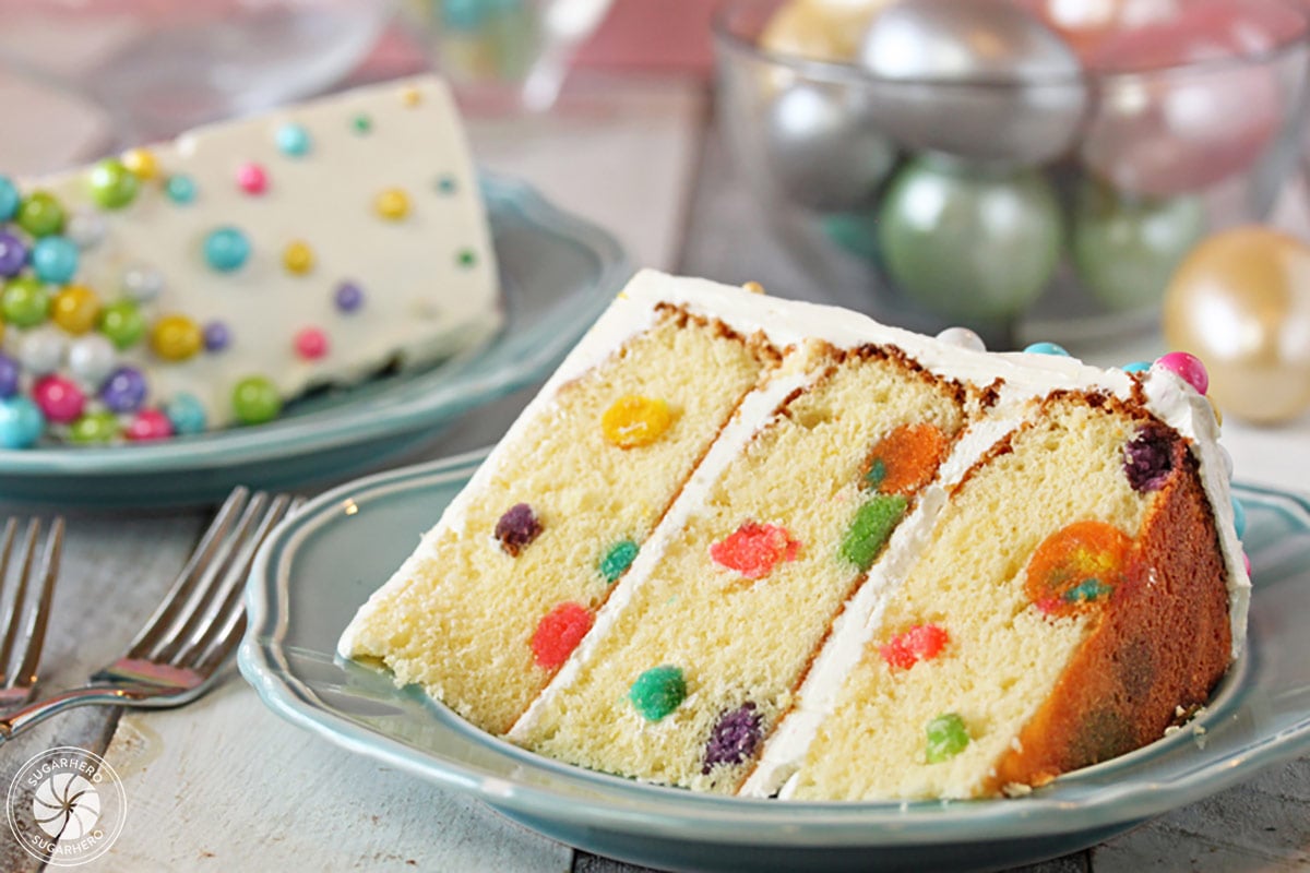 A slice of Easter Polka Dot Cake on a light blue plate.