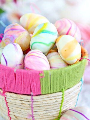 Pile of Marbled Easter Egg Truffles in a woven Easter basket.