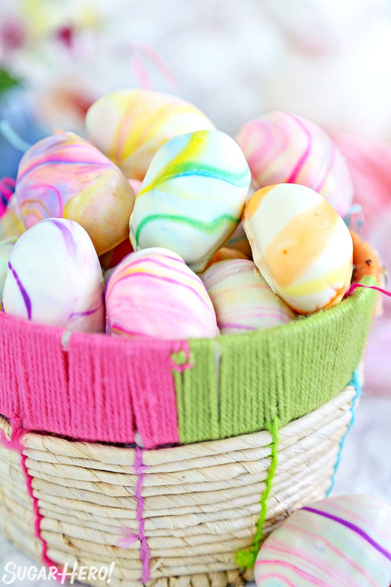 Marbled Easter Egg Truffles - Truffles displayed in a basket. | From SugarHero.com