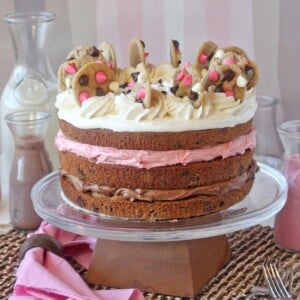 Close up of a Neapolitan Chocolate Chip Cookie Cake on a clear cake platter.