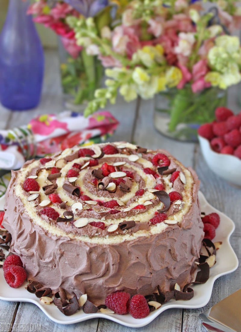 Raspberry Almond Spiral Cake - almond cake, chocolate whipped cream, and berries, rolled into a spiral! | From SugarHero.com
