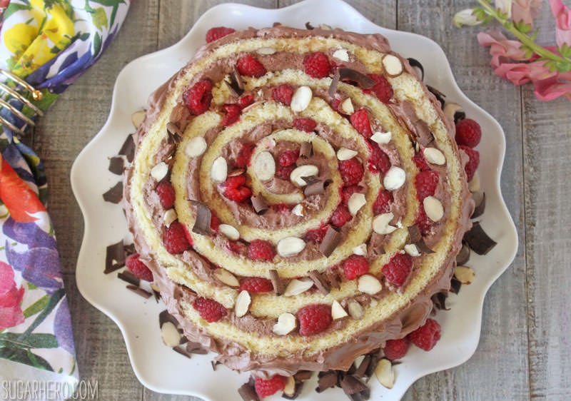 Raspberry Almond Spiral Cake - almond cake, chocolate whipped cream, and berries, rolled into a spiral! | From SugarHero.com