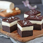 4 Goat Cheese Brownies on a wooden cutting board.