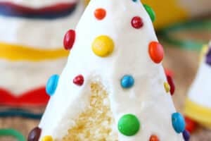 A decorated Birthday Party Cake Hat with a bite removed to show the center.