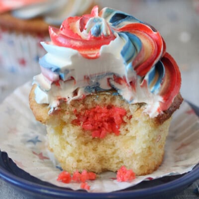 Close up of an Exploding Cupcake with a bit removed to show the pop rocks in the middle.