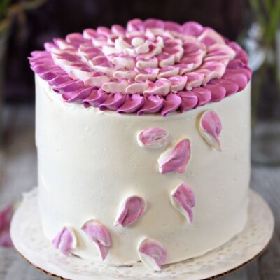 Close up of a Radiant Orchid Mini Cake with orchid petals.