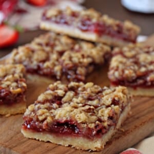 Strawberry Basil Crumb Bars cut in squares on a cutting board.