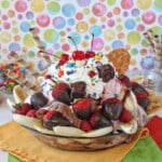 Close up of an Ultimate Banana Split on multi-colored napkins.