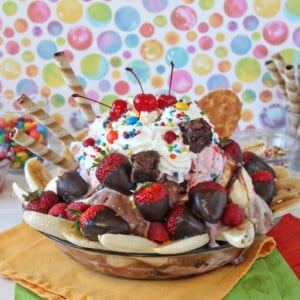 Close up of an Ultimate Banana Split on multi-colored napkins.