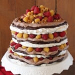 Close up of a Hazelnut Meringue Cake on a white platter.