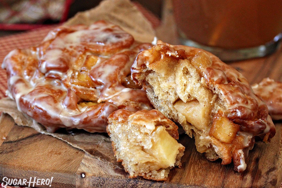 Apple Cider Fritter with cut away section showing inside dough and apple chunks.