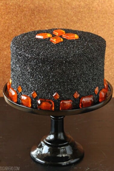 Devil's Food Cake with Pumpkin Butterscotch Frosting on a black cake stand.