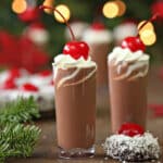 Two small glasses of Cherry Hot Chocolate with fir in the background.