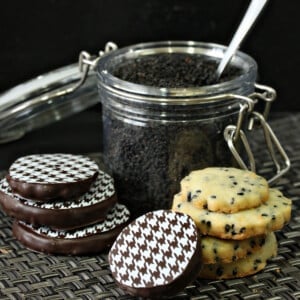 Black Sesame Shortbread Cookies in front of a cannister of black sesame seeds.