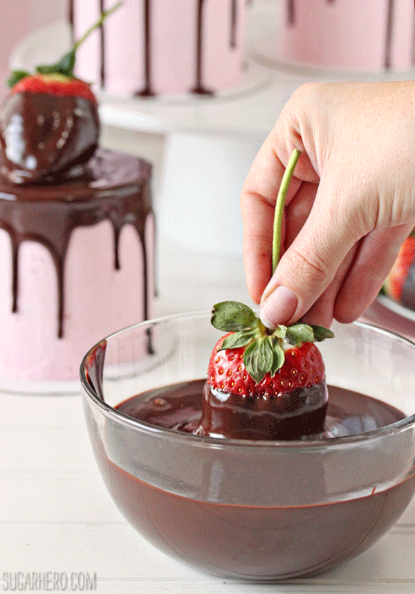Chocolate-Covered Strawberry Cakes - A motioned picture of a strawberry being dipped in chocolate. | From SugarHero.com